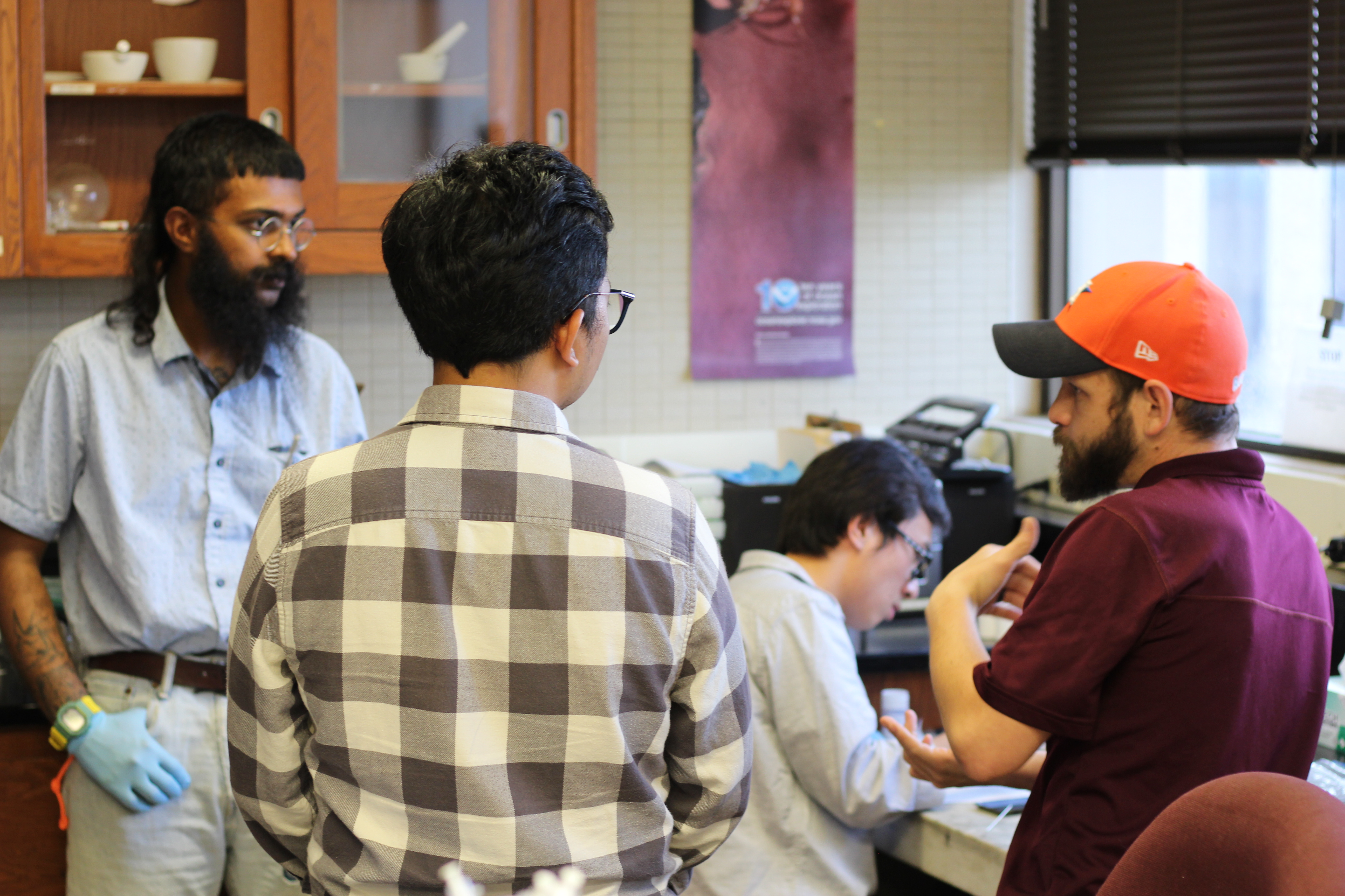 Graduate Students talking in lab